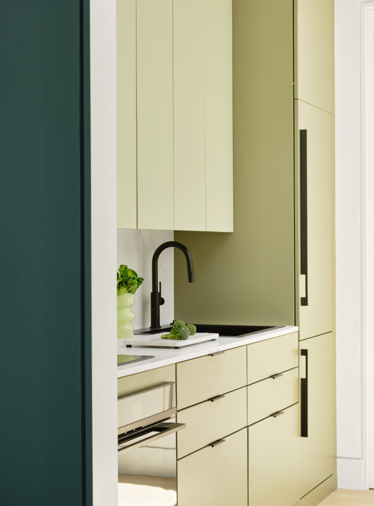 Bright, open ADU living space with oak accents, green cabinetry, and circular skylight in Lafayette, California.